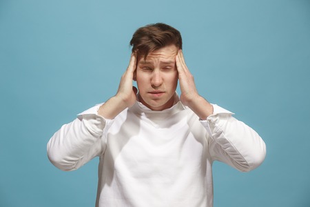 Man having headache. Isolated over background.の写真素材