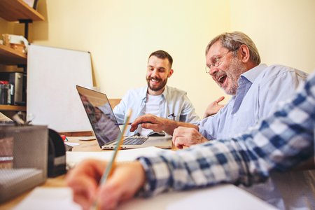 Team job. Photo young businessmans working with new project in officeの写真素材