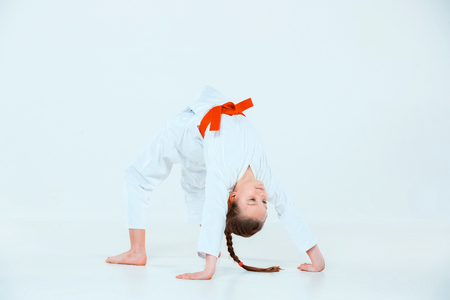 The girl posing at Aikido training in martial arts school. Healthy lifestyle and sports conceptの写真素材