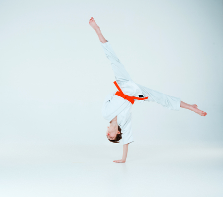 The boy posing at Aikido training in martial arts school. Healthy lifestyle and sports concept
