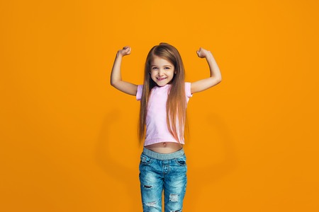 Happy success teen girl celebrating being a winner. Dynamic energetic image of female model