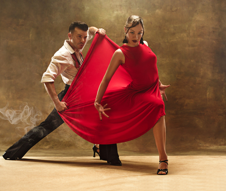 Flexible young modern dance couple posing in studio.の写真素材