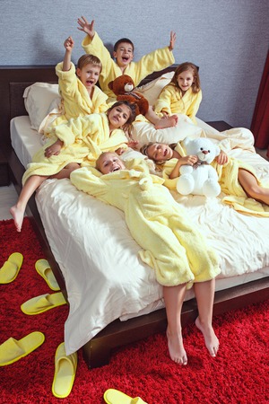Large group of friends taking goog time on bedの写真素材