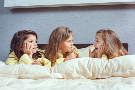 The group of girlfriends taking goog time on bedの写真素材