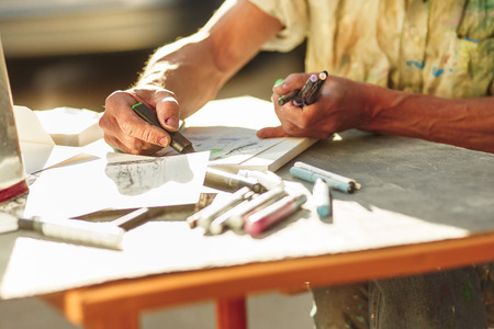 Close up man working of Architect sketching a construction project on his plane project at site construction workの写真素材