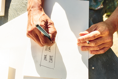 Close up man working of Architect sketching a construction project on his plane project at site construction workの写真素材