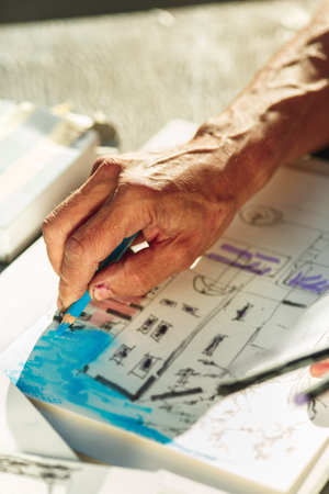 Close up man working of Architect sketching a construction project on his plane project at site construction workの写真素材