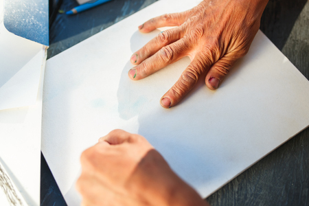Close up man working of Architect sketching a construction project on his plane project at site construction workの写真素材
