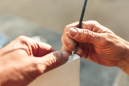 Close up man working of Architect sketching a construction project on his plane project at site construction workの写真素材