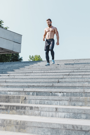 Fit man doing exercises outdoors at cityの写真素材