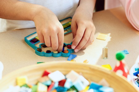 mosaic puzzle art for kids, childrens creative game. two sisters are playing mosaic