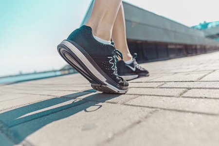 Pretty sporty woman jogging at cityの写真素材