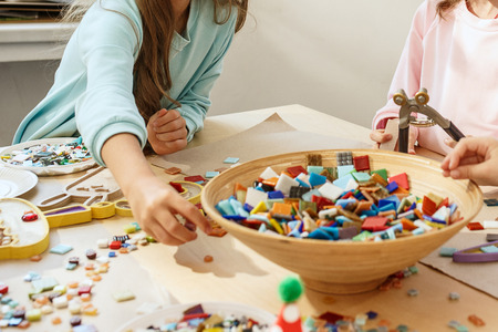mosaic puzzle art for kids, childrens creative game. two sisters are playing mosaic