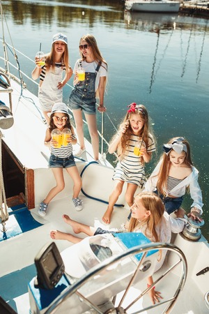 The children on board of sea yachtの写真素材
