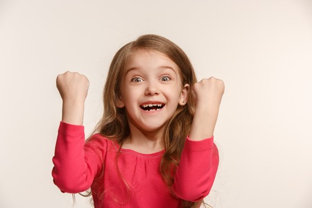Happy success teen girl celebrating being a winner. Dynamic energetic image of female modelの写真素材