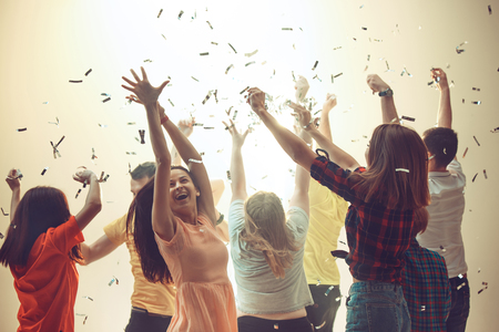 Nightlife and disco concept. Young people are dancing in club.の写真素材