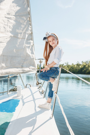 The children on board of sea yachtの写真素材