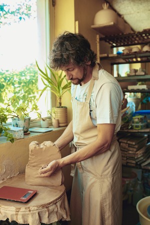 Creating a jar or vase of white clay close-up. Master crock.