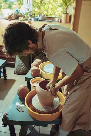 Creating a jar or vase of white clay close-up. Master crock.