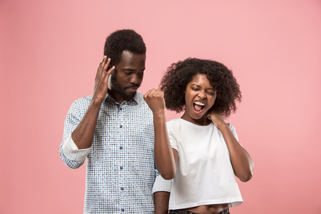 Couple watching sports match on tv at home, celebrating victory, successful gameの写真素材