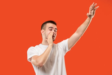 Isolated on pink young casual man shouting at studio