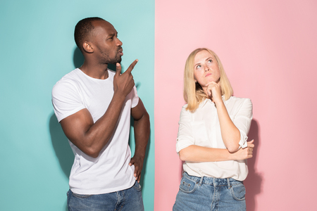 Young serious thoughtful businessman and woman. Doubt concept.の写真素材