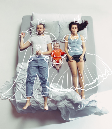 Top view of happy family with one newborn child in bedroom and their dreams .の写真素材
