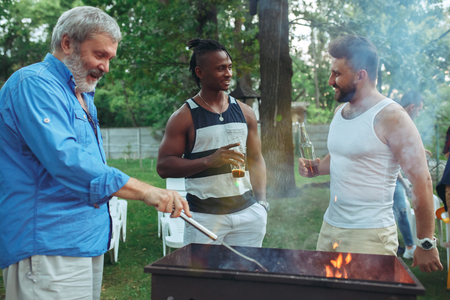 Group of friends making barbecue in the backyard. concept about good and positive mood with friendsの写真素材