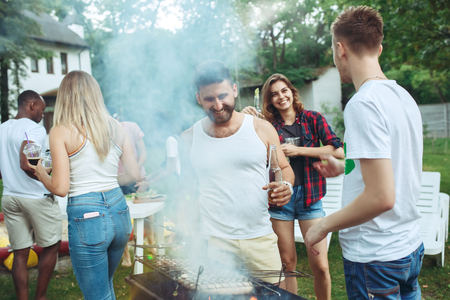 Group of friends making barbecue in the backyard. concept about good and positive mood with friendsの写真素材