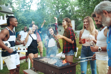 Group of friends making barbecue in the backyard. concept about good and positive mood with friendsの写真素材