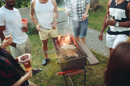 Group of friends making barbecue in the backyard. concept about good and positive mood with friendsの写真素材