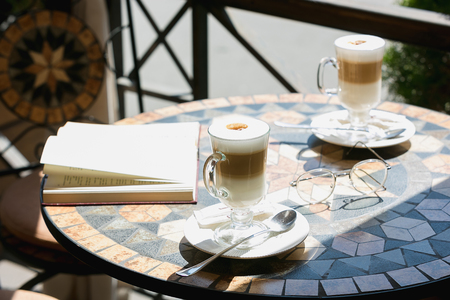 The two cups of coffee with book on table in roomの写真素材