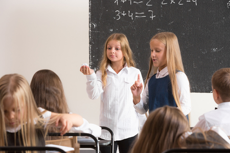 School children in classroom at lesson. The little boys and girls sitting at desks. Back to school, education, classroom, lesson, learn, lifestyle, childhood conceptの写真素材