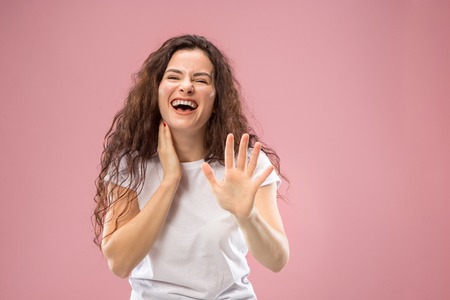 Happy business woman standing and smiling isolated on pink studio background. Beautiful female...