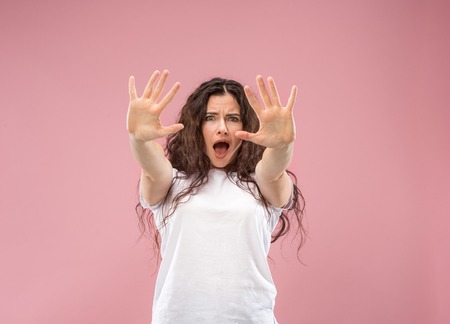 Im afraid. Fright. Portrait of the scared woman. Business woman standing isolated on trendy pink...
