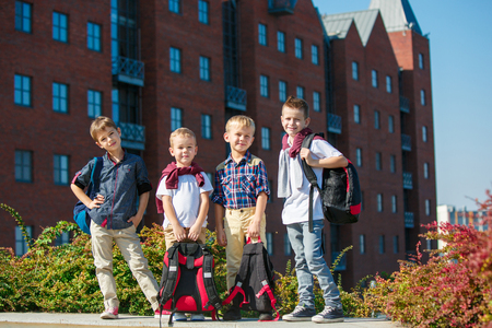A group of happy smiling children of school and preschool age are standing against sity. The childhood, Kids fashion, school, education, friends, lifestyle, leisure, schoolchildren conceptの写真素材