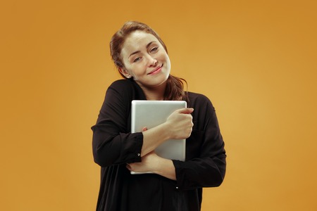 Businesswoman hugging laptop. Love to computer concept. Attractive female half-length front...
