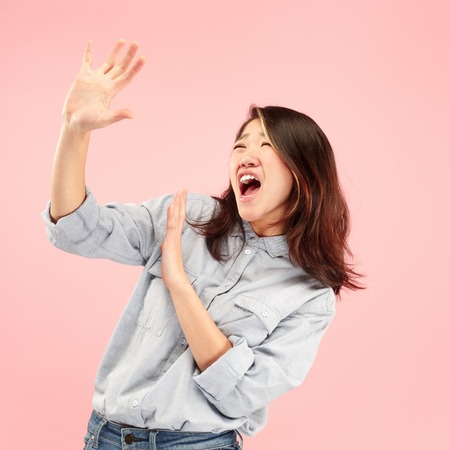 Im afraid. Fright. Portrait of the scared woman. Business woman standing isolated on trendy pink studio background. Female half-length portrait. Human emotions, facial expression concept. Front viewの写真素材