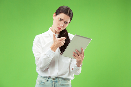 Businesswoman with laptop. Love to computer concept. Attractive female half-length front portrait, trendy green studio backgroud. Young emotional pretty woman. Human emotions, facial expressionの写真素材