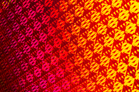 Texture of colored foil with holographic effect. Christmas, New Year, holiday, festival, carnival...