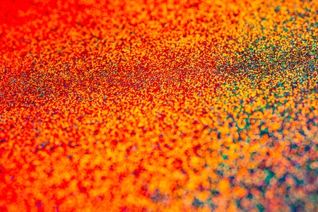 Texture of colored foil with holographic effect. Christmas, New Year, holiday, festival, carnival...