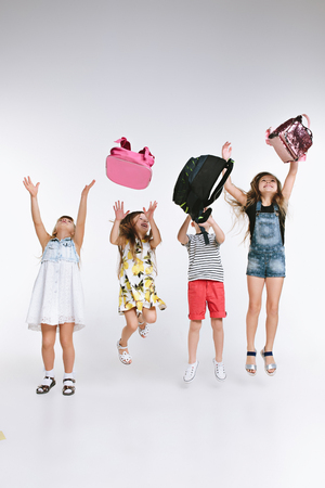 Happiness group of cute and adorable teen children or students are back to school. over white studio background. The friendship, education, childhood, kids fashion conceptの写真素材