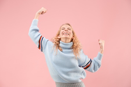 I won. Winning success happy woman celebrating being a winner. Dynamic image of caucasian female model on pink studio background. Victory, delight concept. Human facial emotions concept. Trendy colorsの写真素材