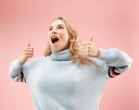 I am ok. Happy woman, sign ok, smiling, isolated on trendy pink studio background. Beautiful female half-length portrait. Emotional woman. Human emotions, facial expression conceptの写真素材