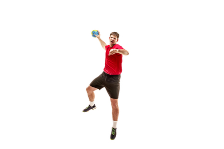 The fit caucasian young male handball player at studio on white background. Fit athlete isolated on white. The man in action, motion, movement. attack and defense conceptの写真素材