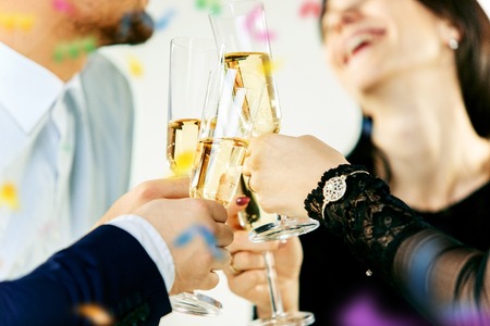 Celebration. Hands holding the glasses of champagne and wine making a toast.の写真素材