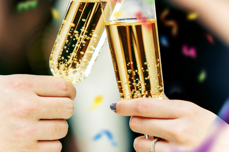 Celebration. Hands holding the glasses of champagne and wine making a toast.の写真素材