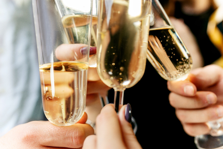 Celebration. Hands holding the glasses of champagne and wine making a toast.の写真素材