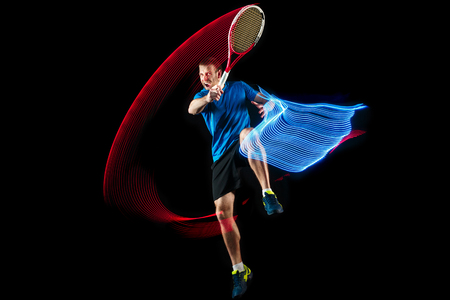 The one caucasian man playing tennis isolated on blackの写真素材