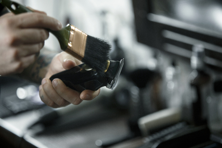 The male hands and tools for cutting beard at barbershop. Vintage tools of barber shop